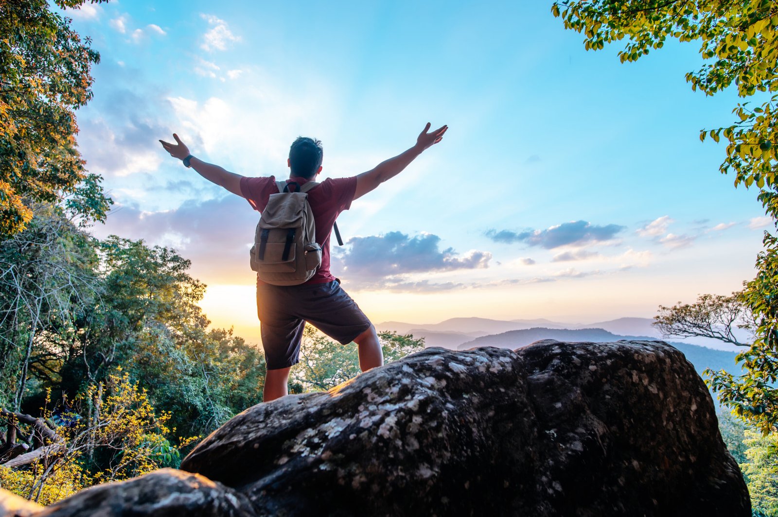 Young trekking man standing on rocky mountain peak salutetravelscom travel Young trekking man standing on rocky mountain peak